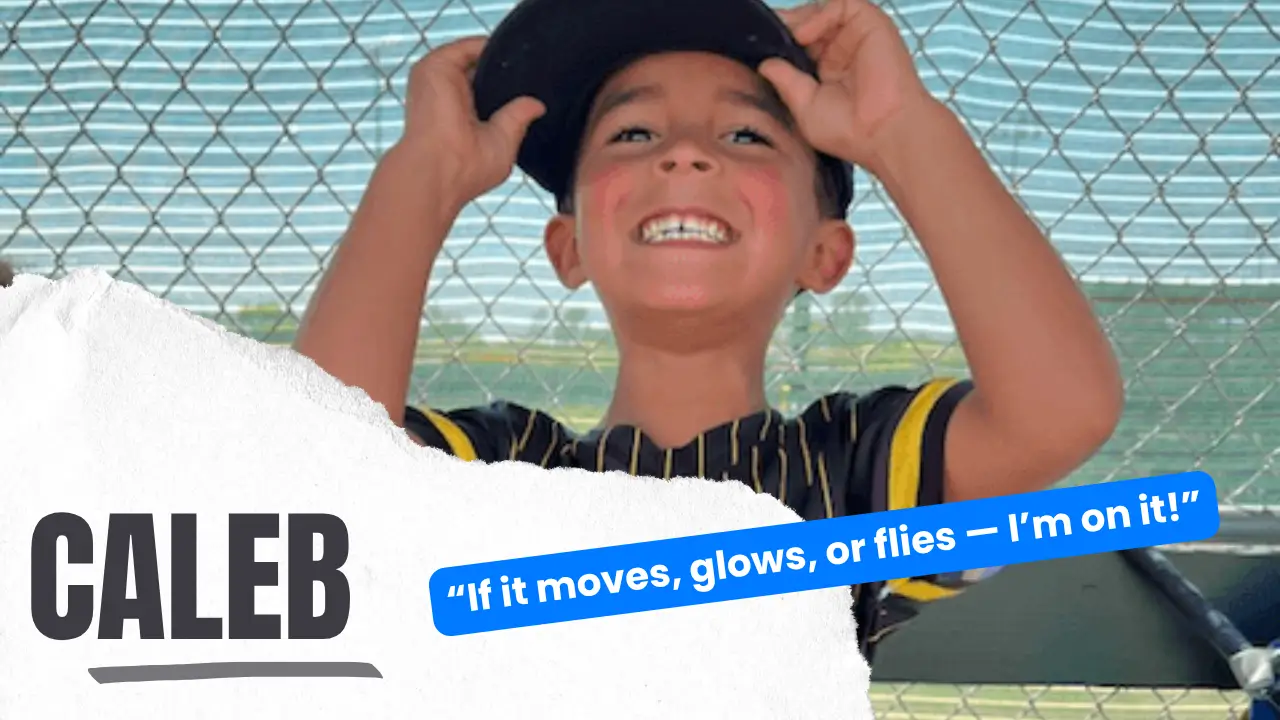 Caleb grinning with his iPad and a pile of LEGO creations, ready to show off his latest science experiment.